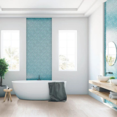Modern bathroom with a white oval bathtub, turquoise tiled accent wall, light wood flooring, and large windows providing natural light.